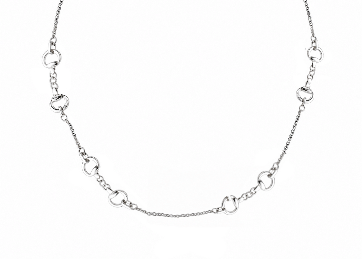A silver-toned chain necklace featuring alternating horse snaffle bit charms
