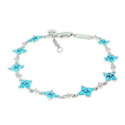 A silver-tone chain bracelet featuring multiple small floral clusters set with bright turquoise blue stones
